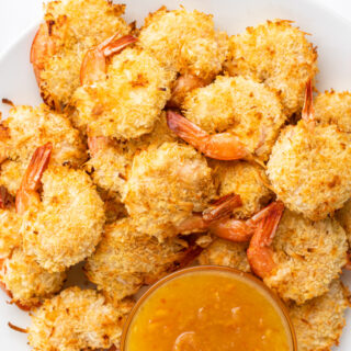 coconut shrimp in a bowl with sauce