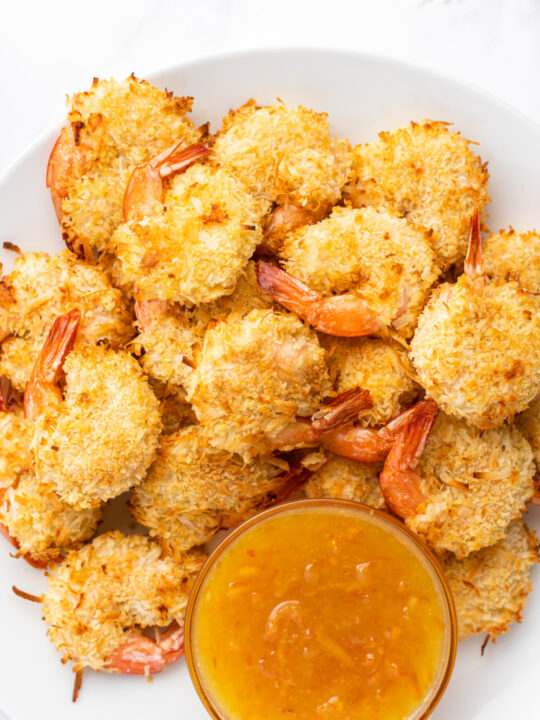 coconut shrimp in a bowl with sauce