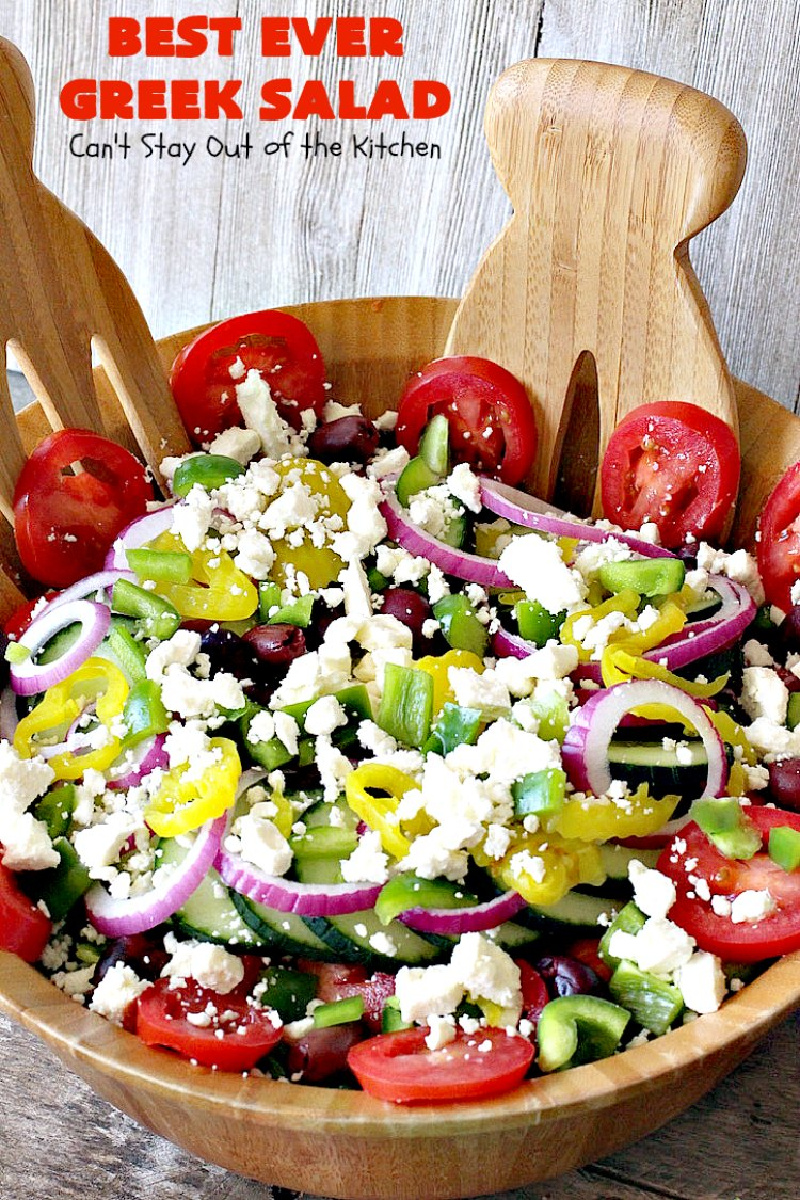 greek salad in wood bowl with servers