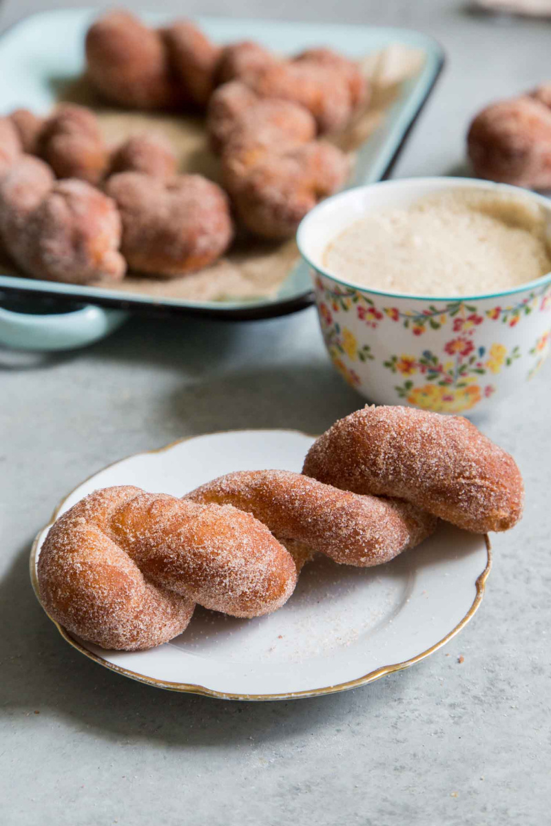 cinnamon sugar twist doughnut on a white plate