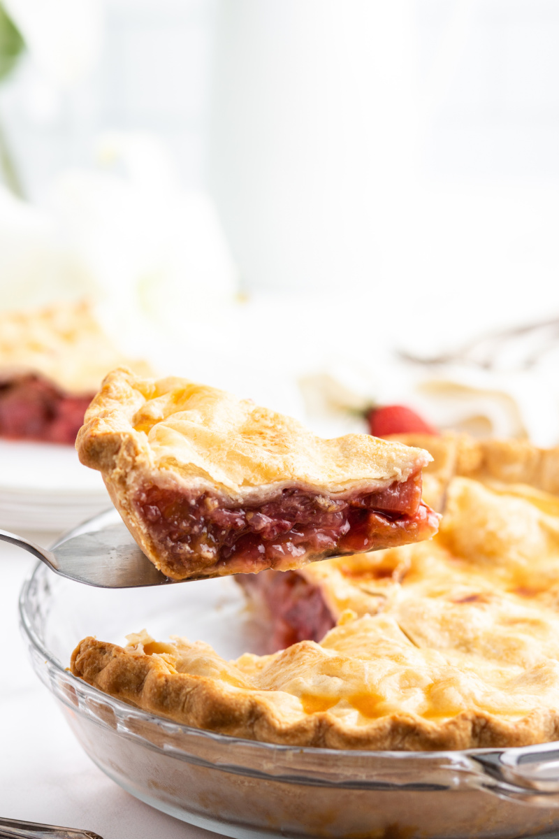 pie server lifting out a slice of easy strawberry rhubarb pie