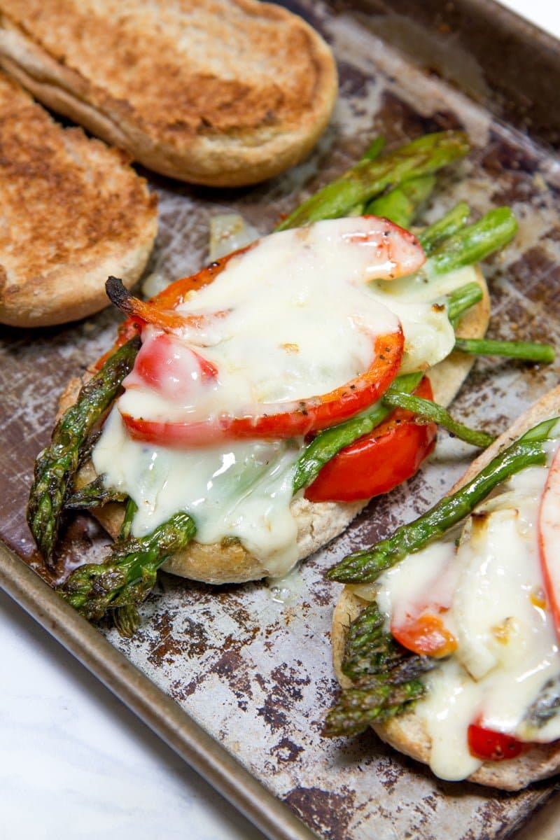 roasted asparagus hoagies open faced on baking sheet