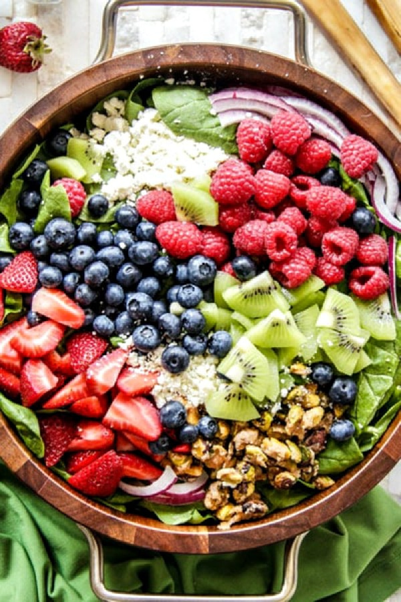 kiwi berry salad in wooden bowl