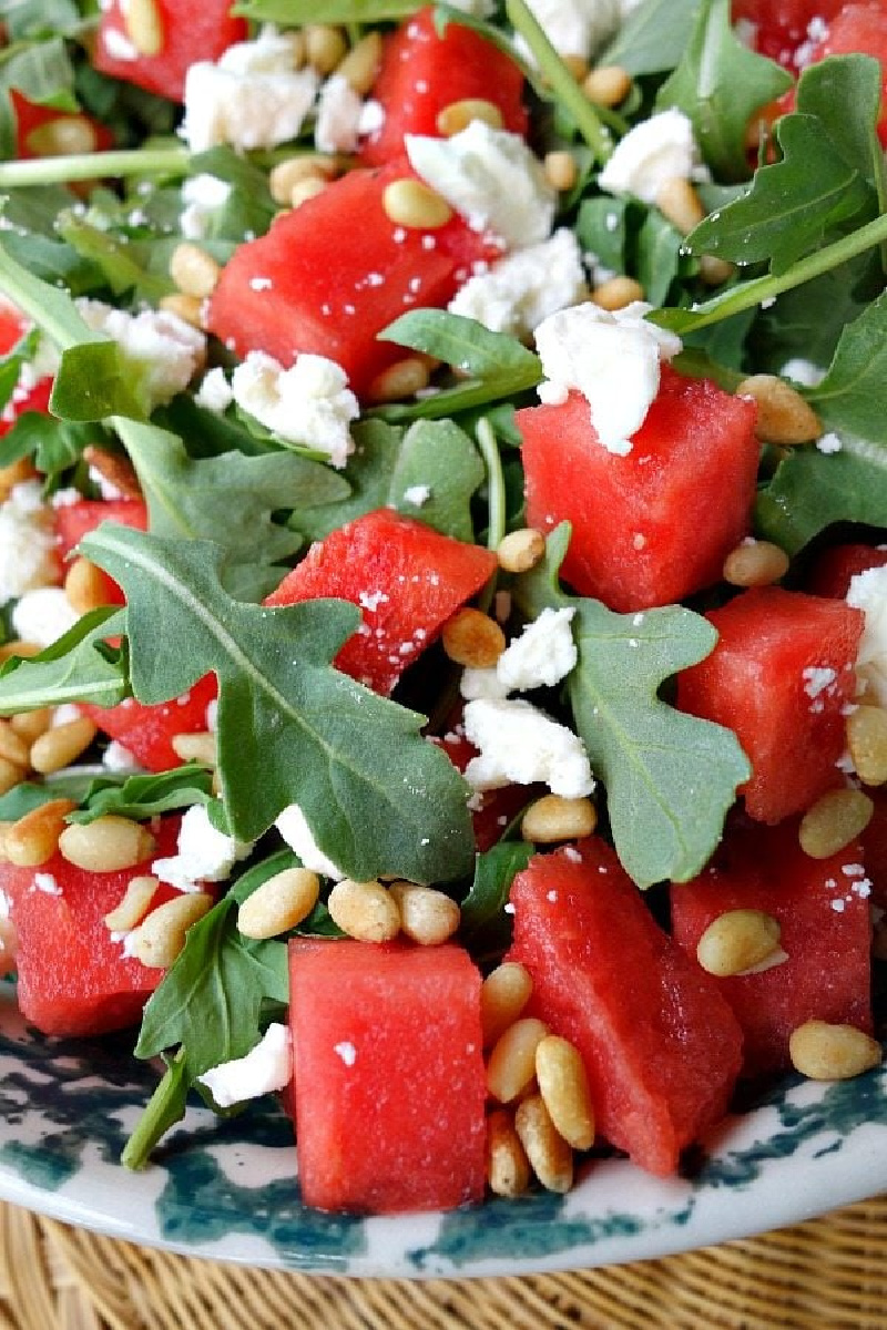 Watermelon feta and arugula salad in white bowl