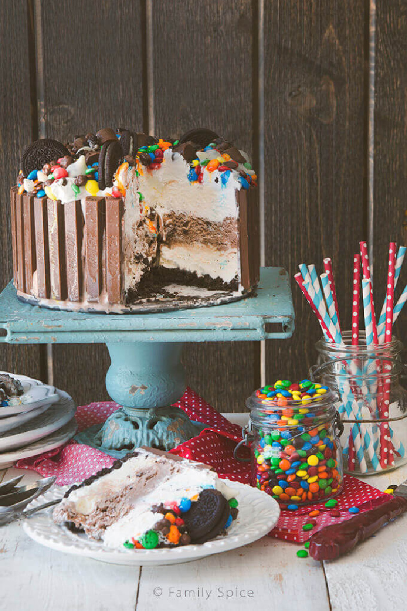 candy shop ice cream cake on a blue cake stand slice taken out of it