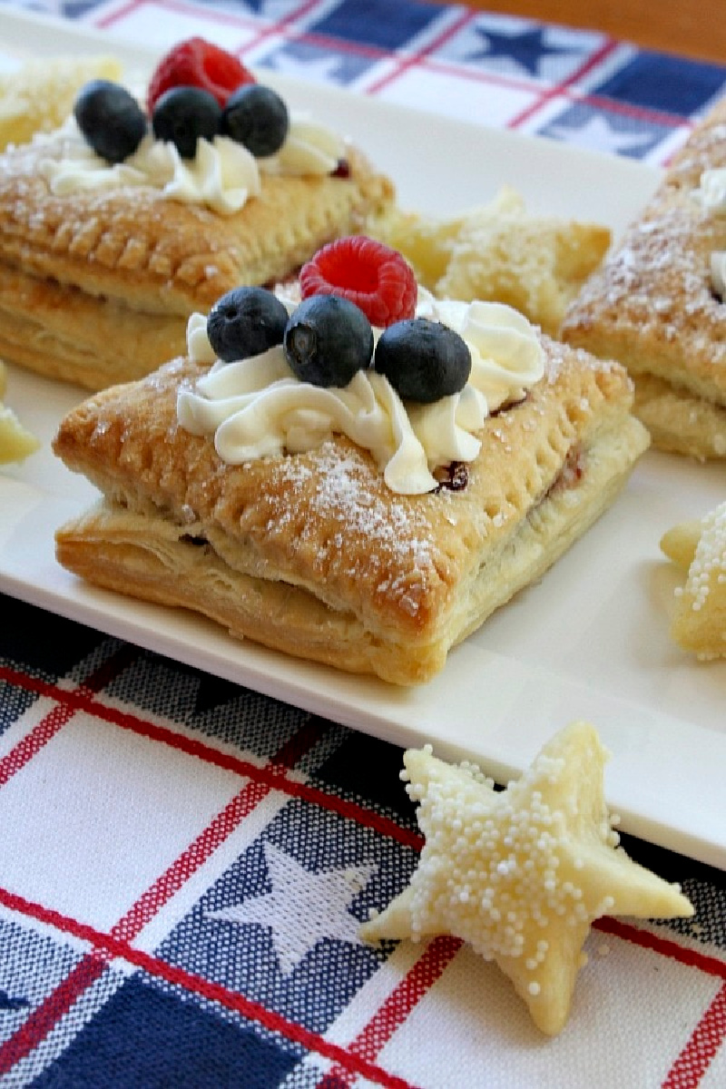 red white and blue pastries with berries and cream