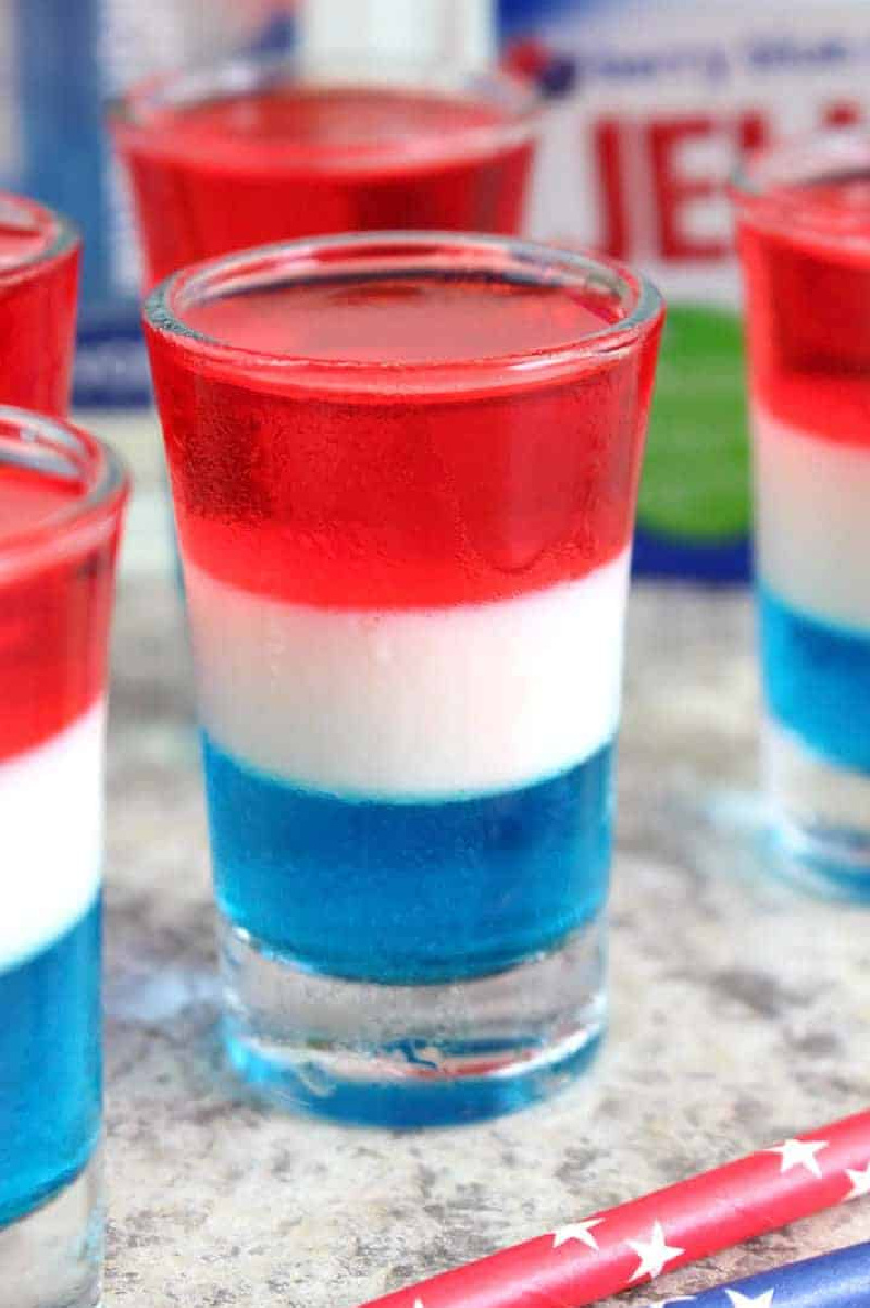 layered red white and blue jello shot in a shot glass