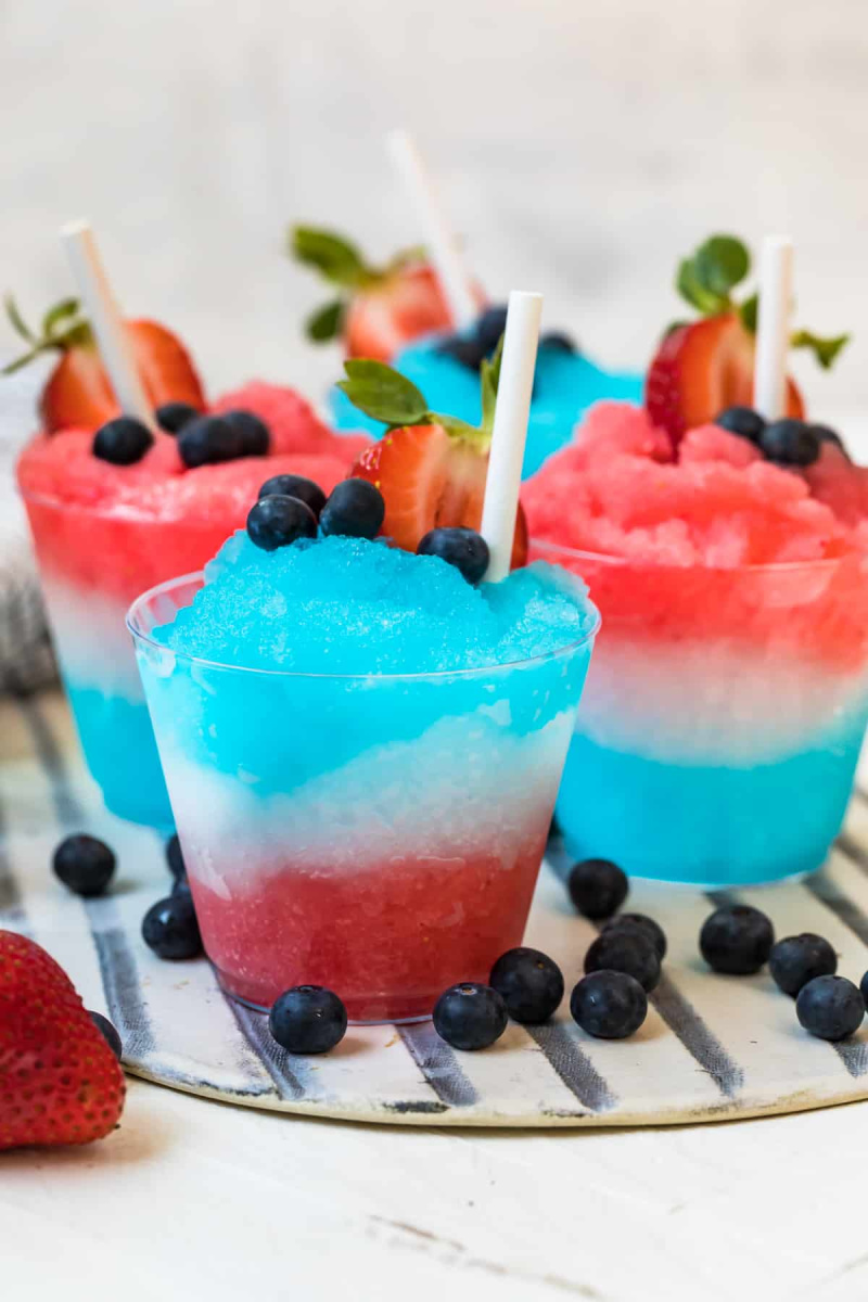 cups of red white and blue margarita slushies