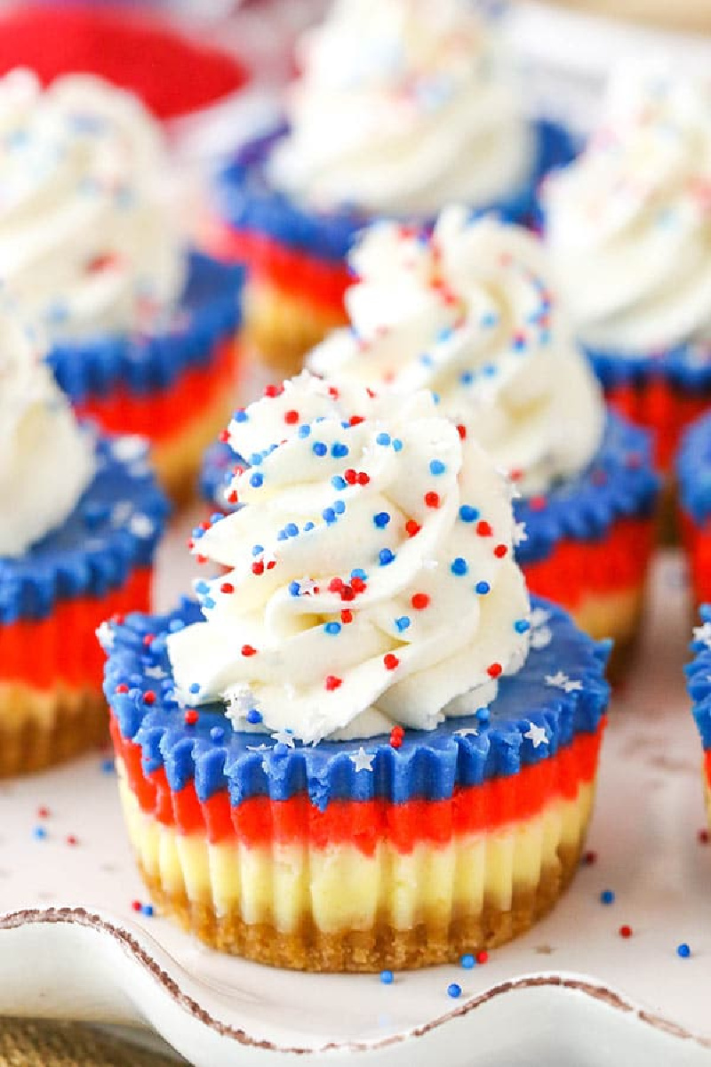 red white and blue mini cheesecakes with whipped cream