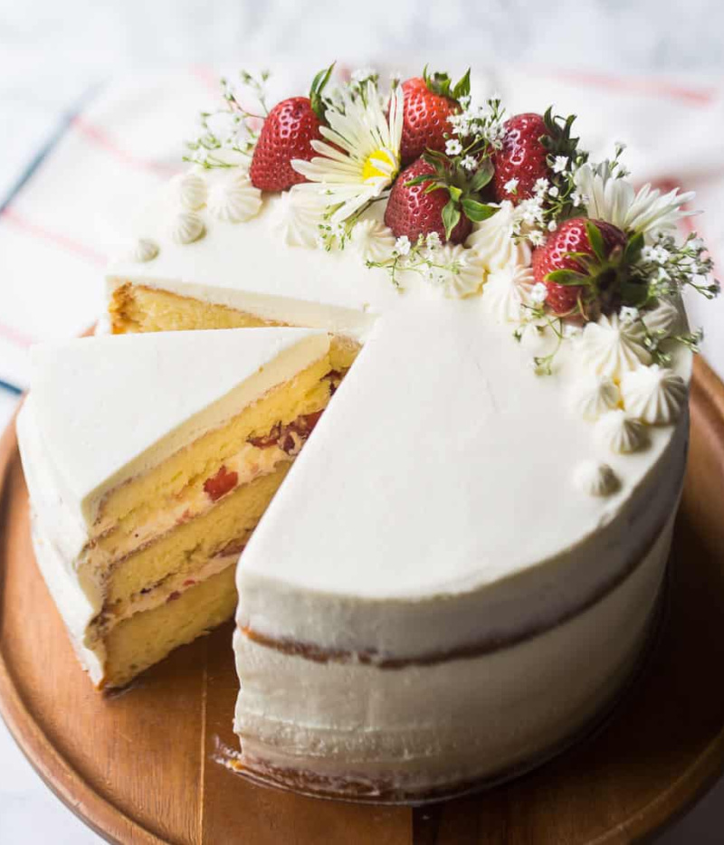 slice being removed from strawberry shortcake layer cake