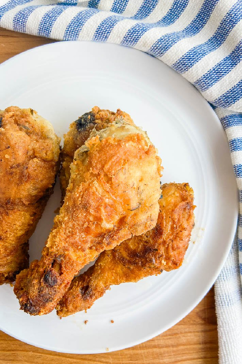 summer savory brined fried chicken on a white plate