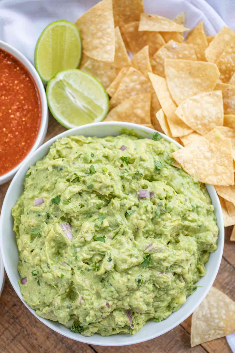 chipotle guacamole in white bowl with chips