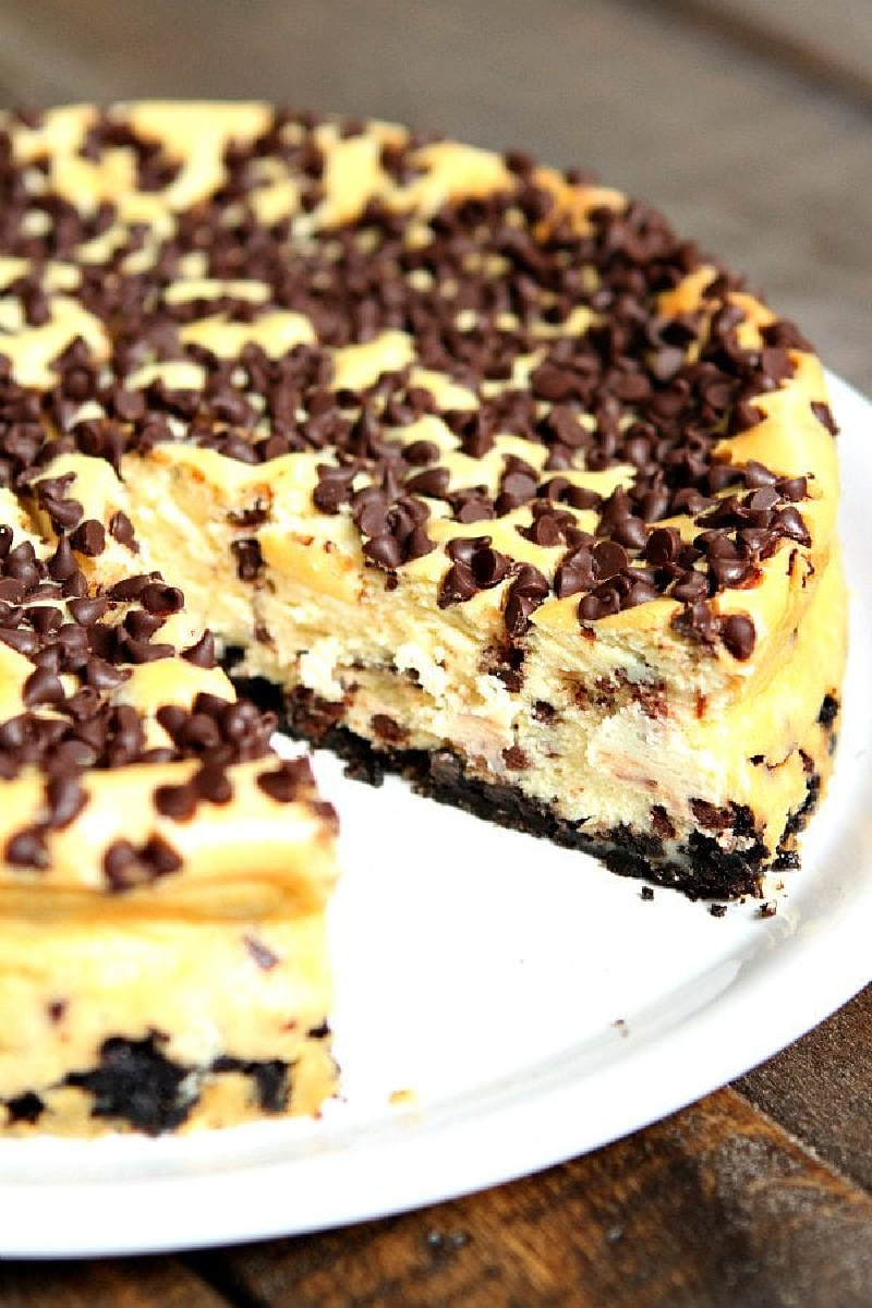 chocolate chip cheesecake with slice taken out of it