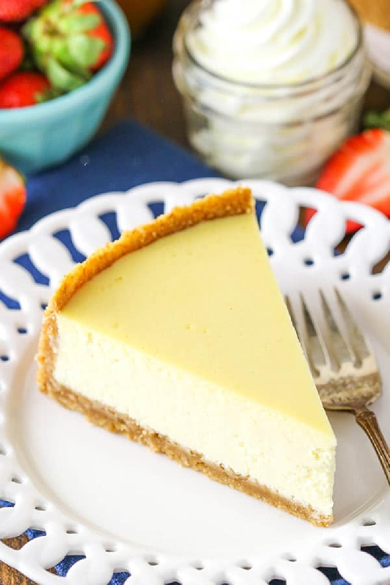 slice of classic cheesecake on white plate