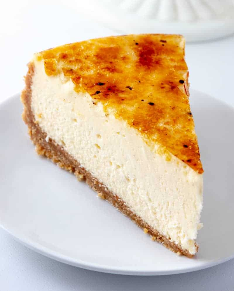slice of creme brulee cheesecake on white plate