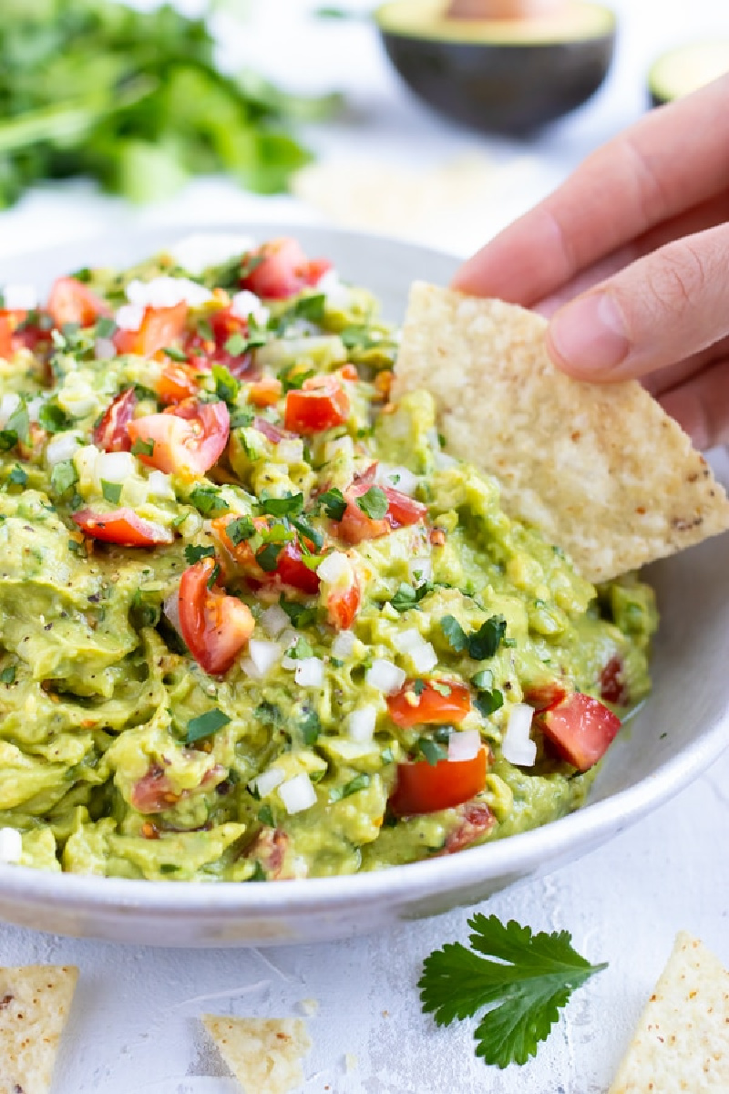 guacamole with chip in bowl