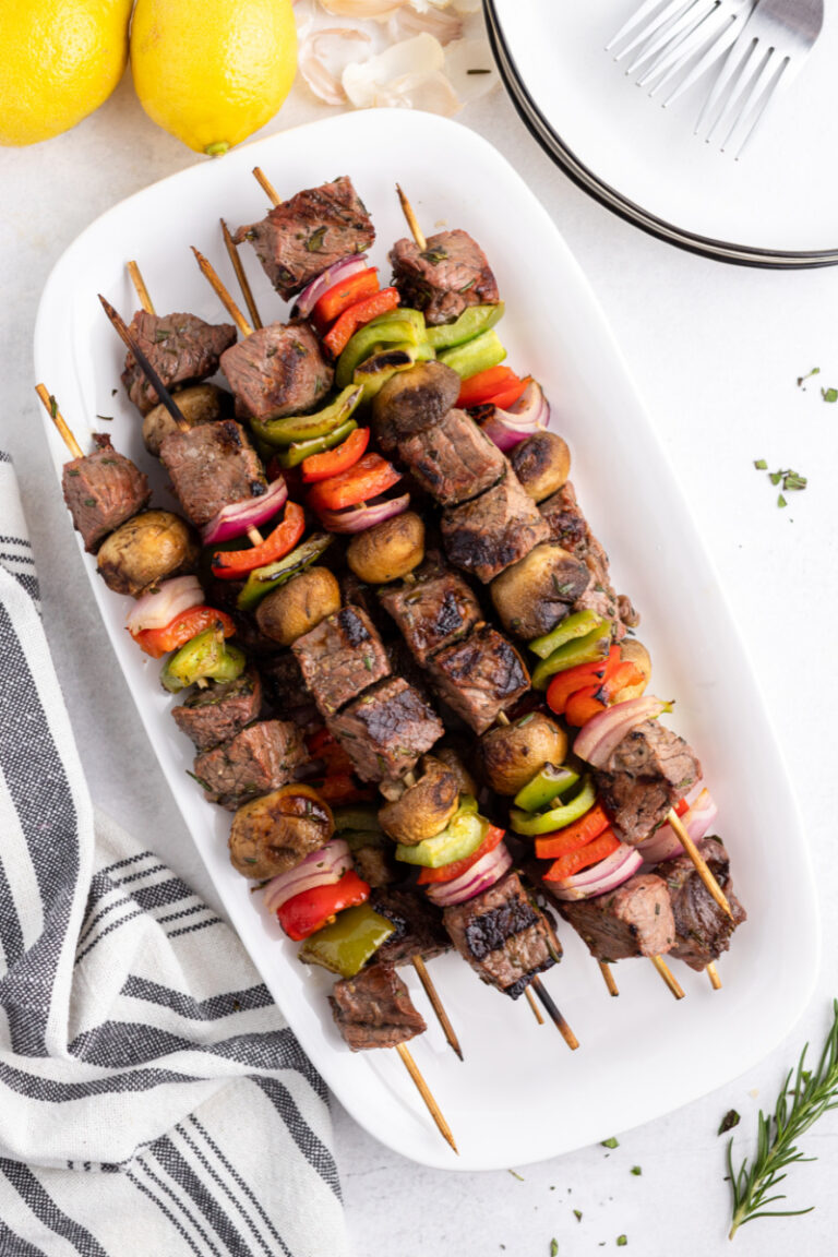 grilled lemon garlic steak kebabs on a white platter