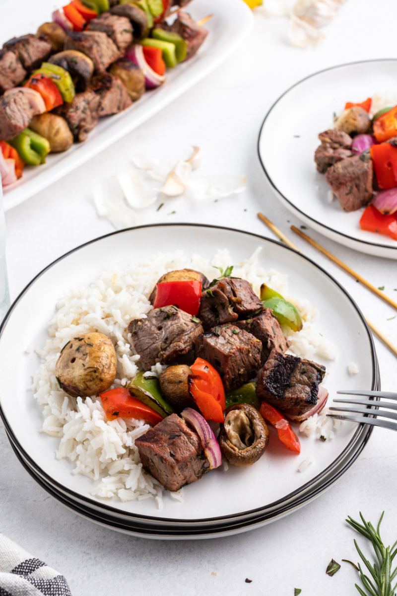 steak and vegetables served with rice on a plate