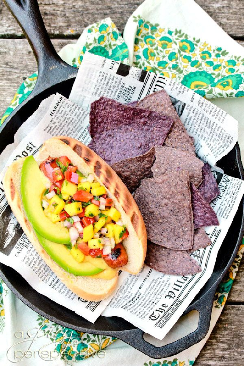 hawaiian hot dog in a paper lined basket with chips