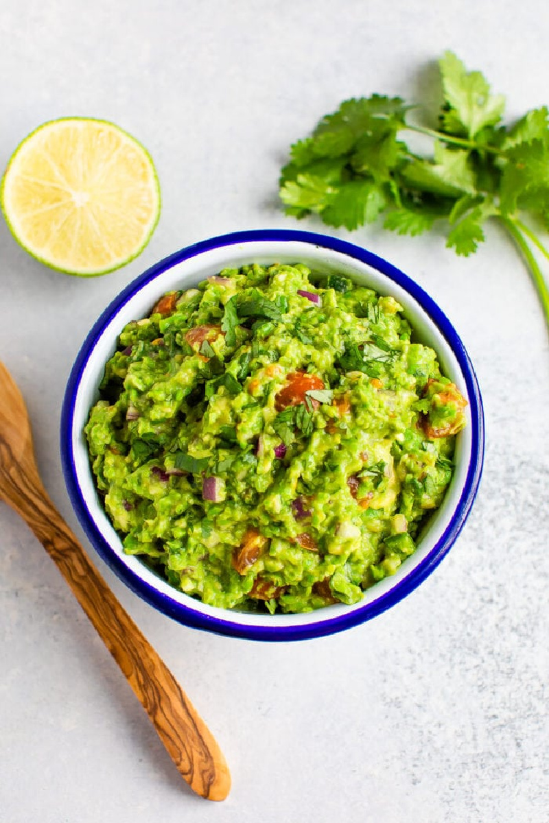 pea guacamole in a blue rimmed bowl