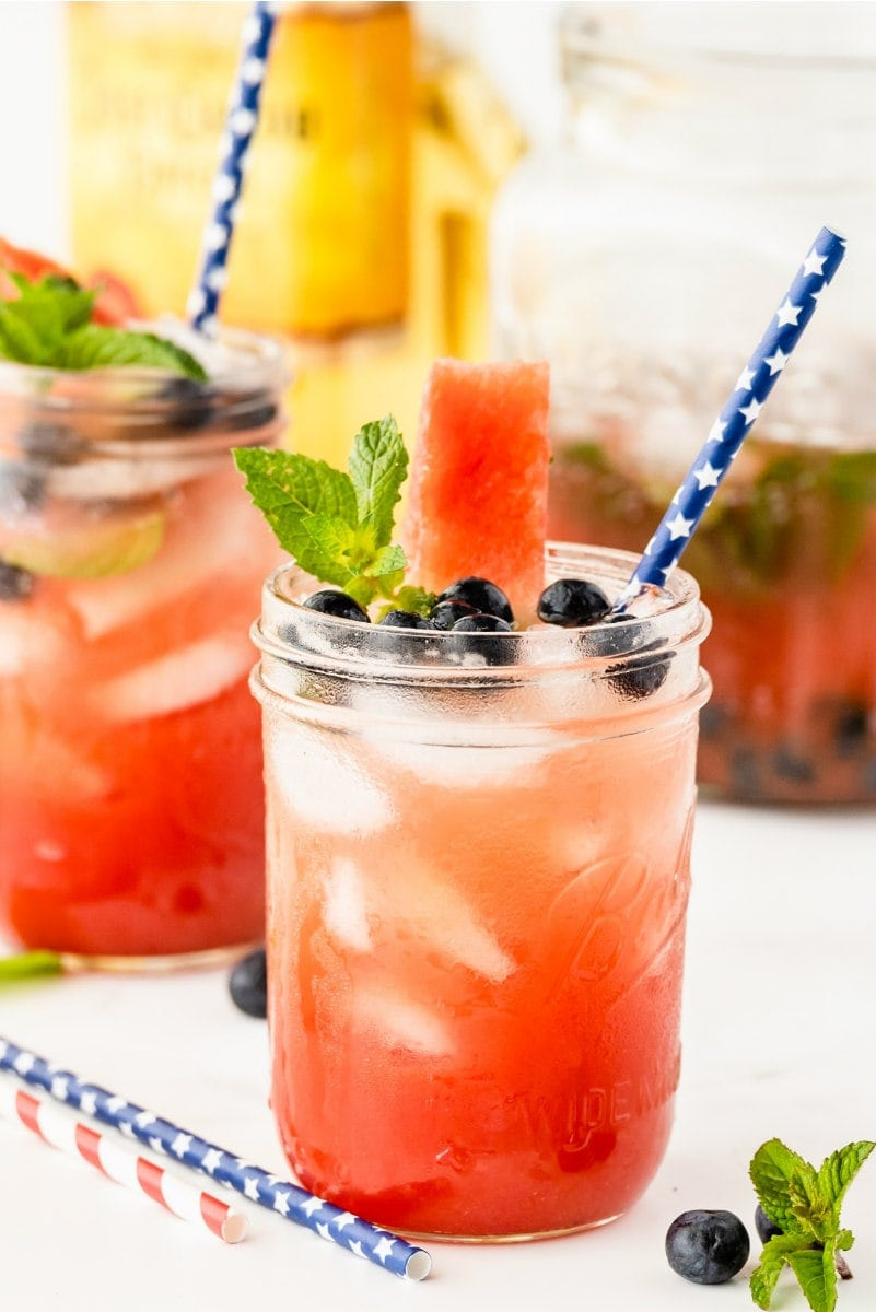 jars of watermelon tequila cocktails with straws