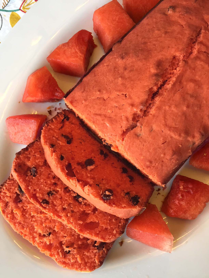 loaf of watermelon bread with slices taken out of it