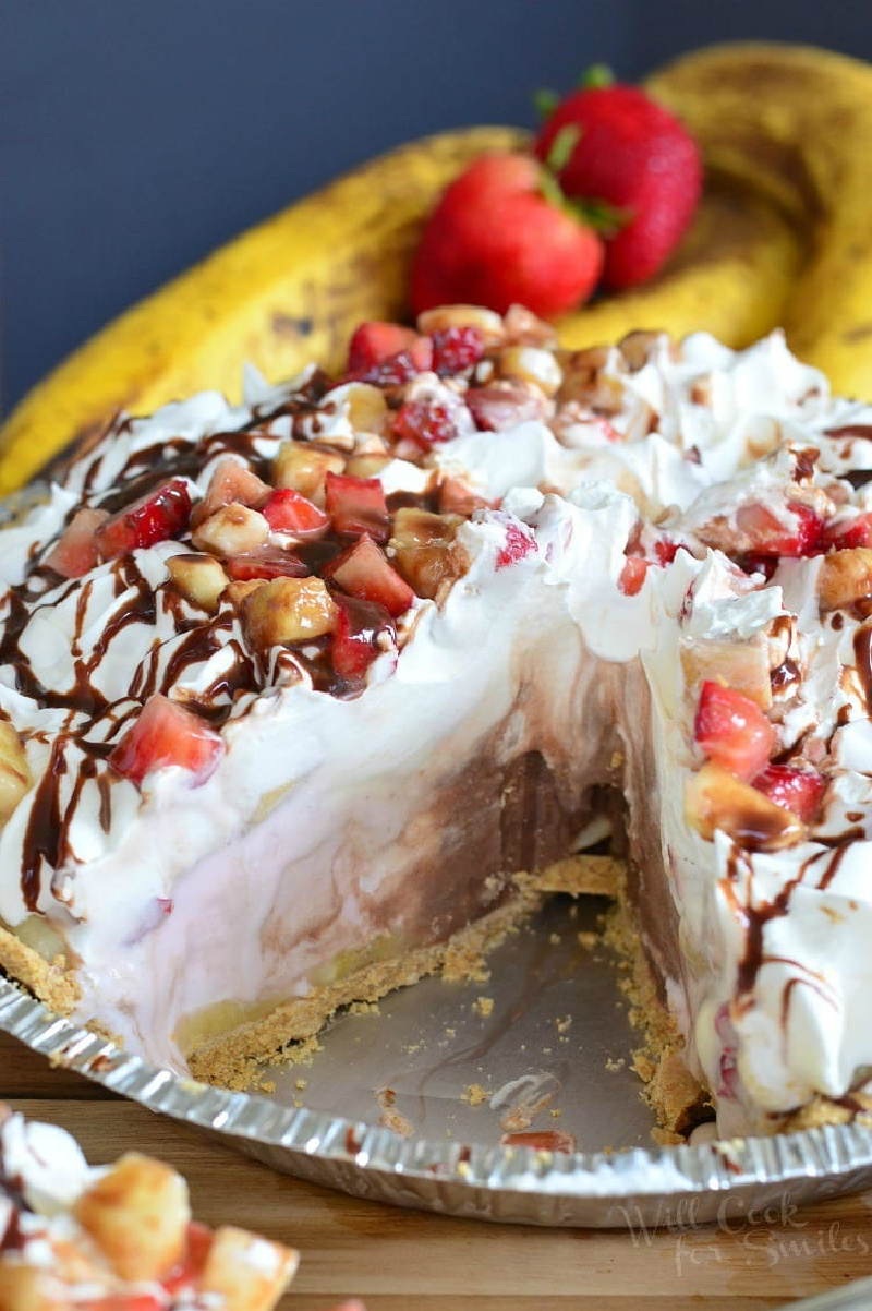 banana split ice cream pie with a slice taken out of it