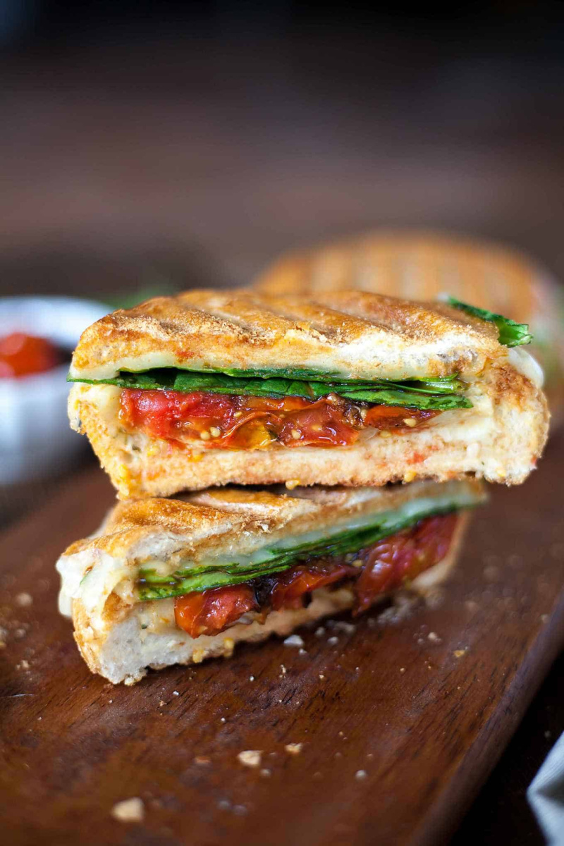 two slices stacked cheesy hummus veggie panini