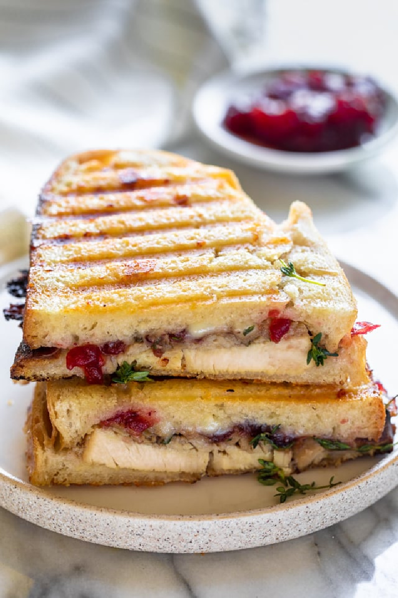 leftover thanksgiving turkey panini on white plate