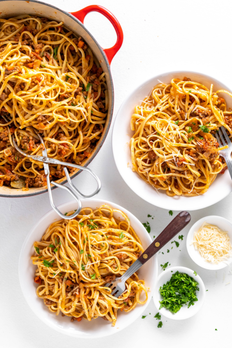 pot of linguine with bolognese with two servings