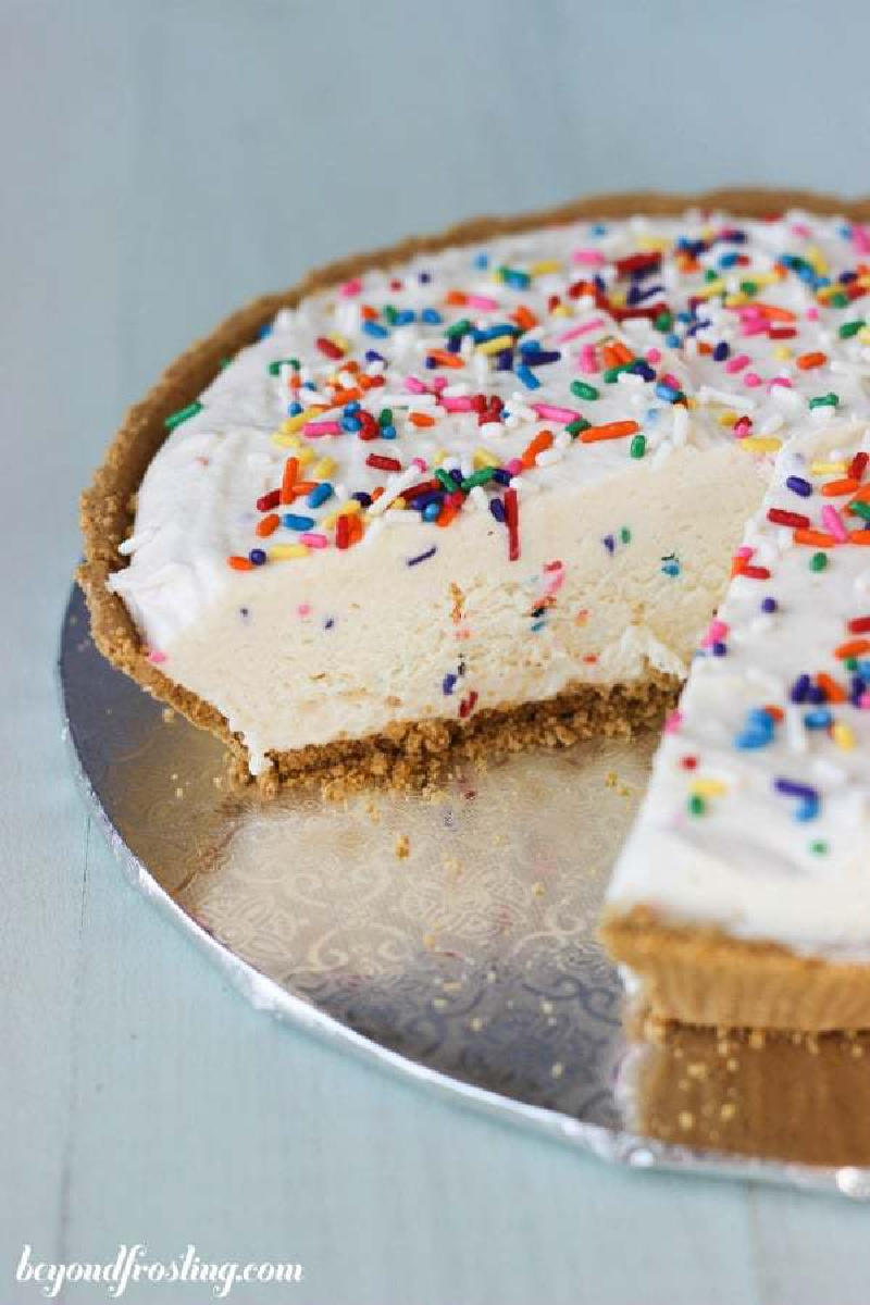 funfetti cheesecake ice cream pie with a slice taken out of it