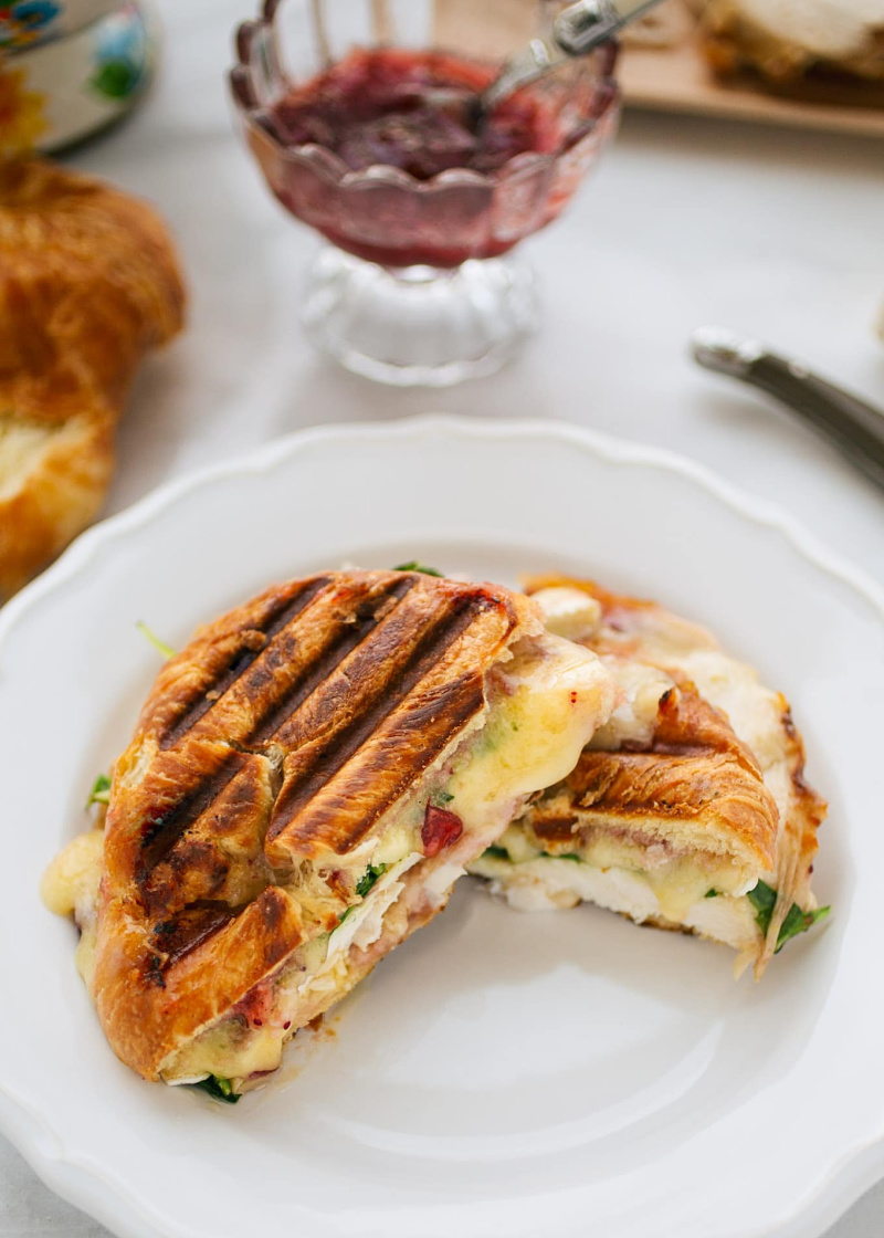 turkey and brie croissant panini on a white plate