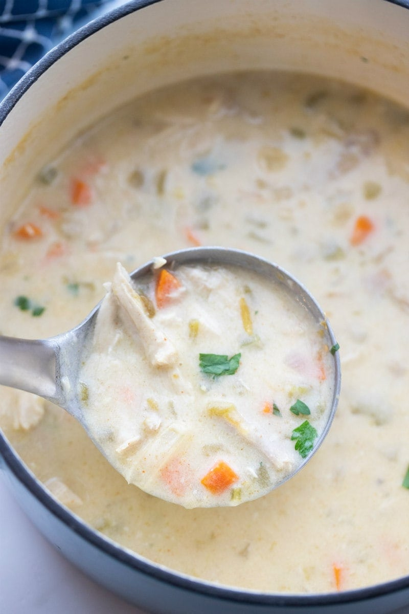 creamy mexican turkey soup with ladle