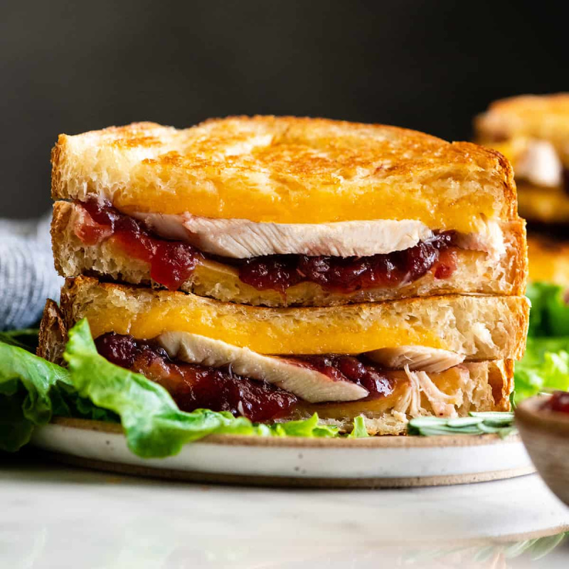 two halves of turkey cranberry sandwich on top of each other