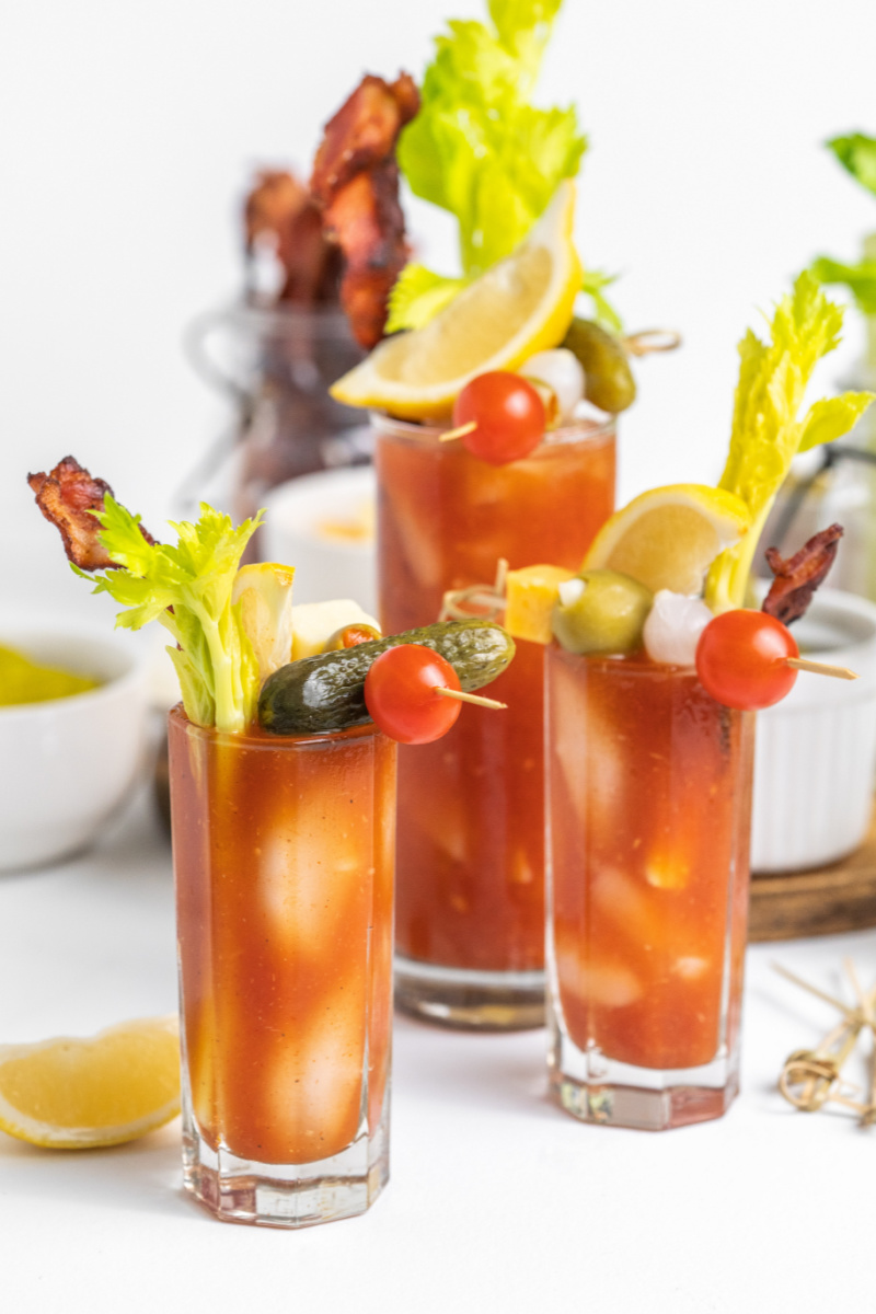 several bloody marys loaded with garnishes