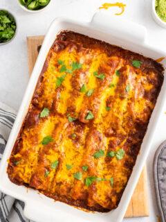 ground beef and cheese enchiladas in a white casserole dish