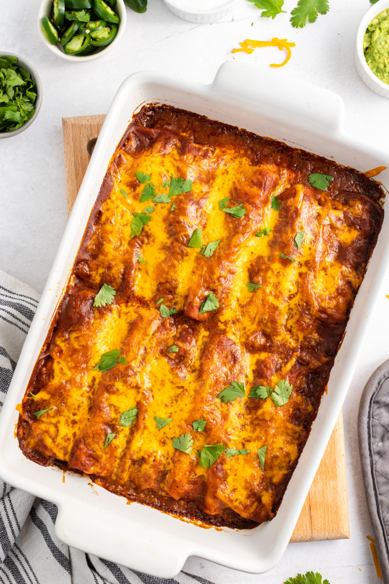 ground beef and cheese enchiladas in a white casserole dish