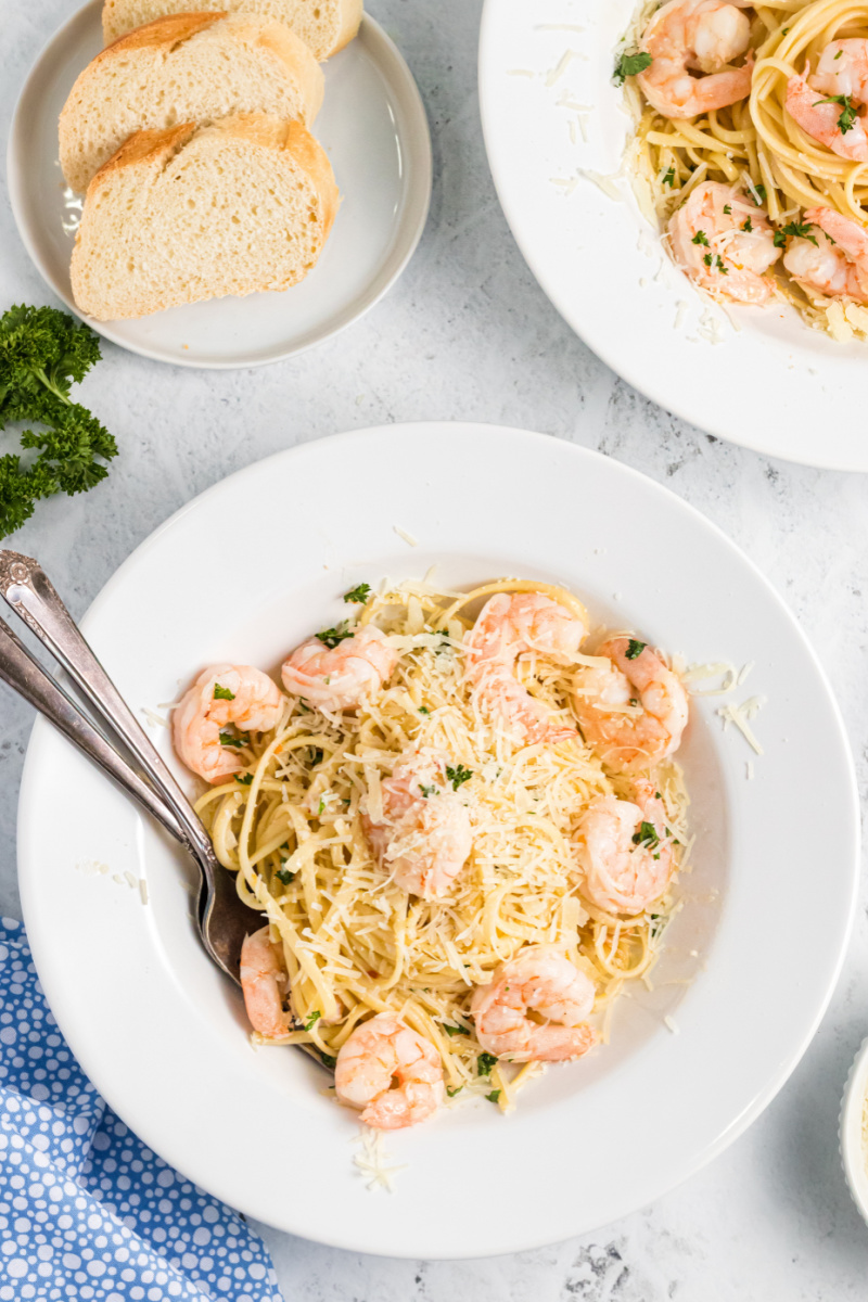 shrimp scampi pasta plated with parmesan on top