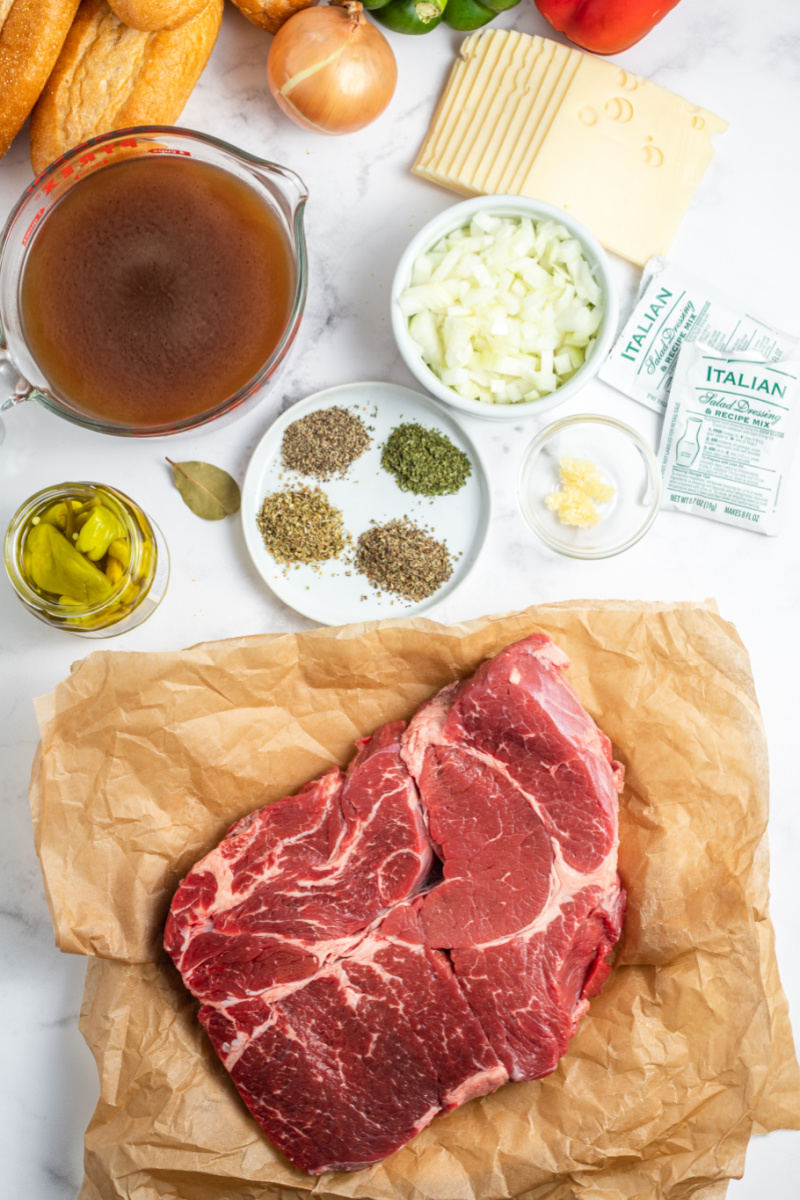 ingredients displayed for making slow cooker italian beef sandwiches