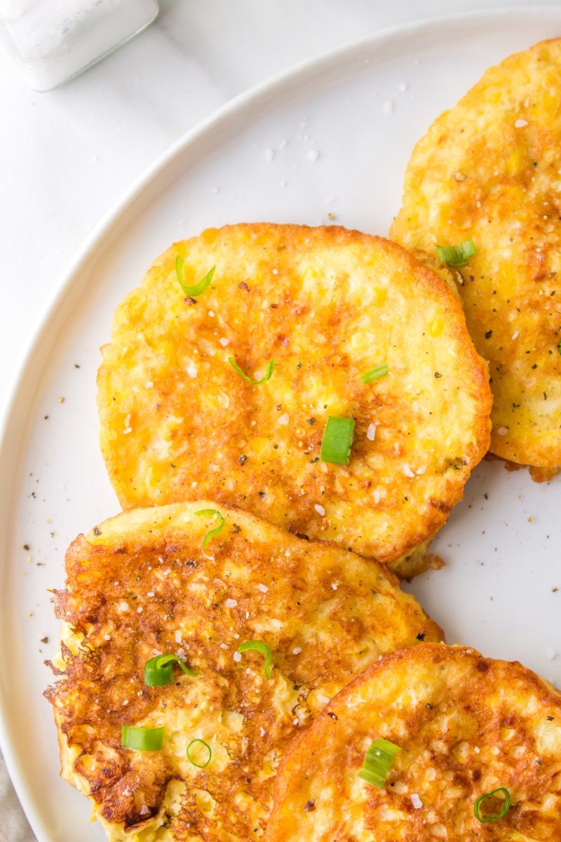 corn fritters spread out on a plate