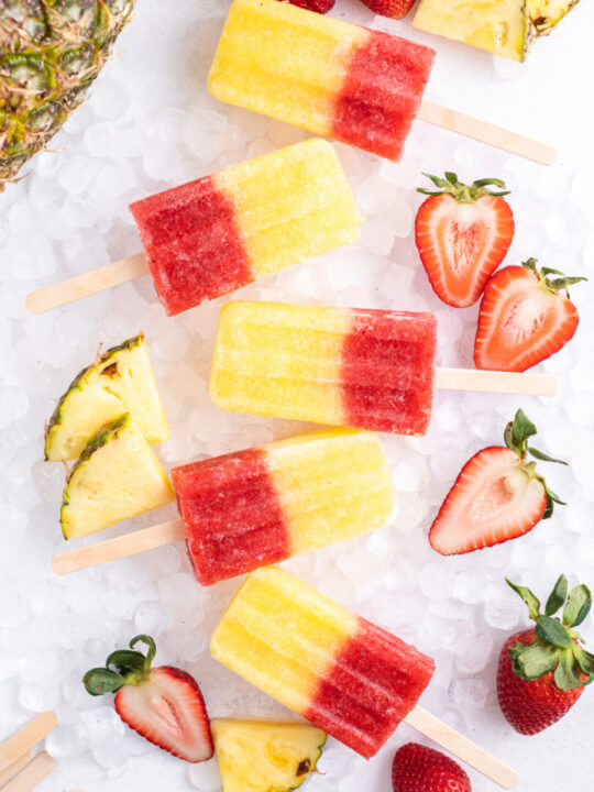 5 strawberry pineapple popsicles on ice