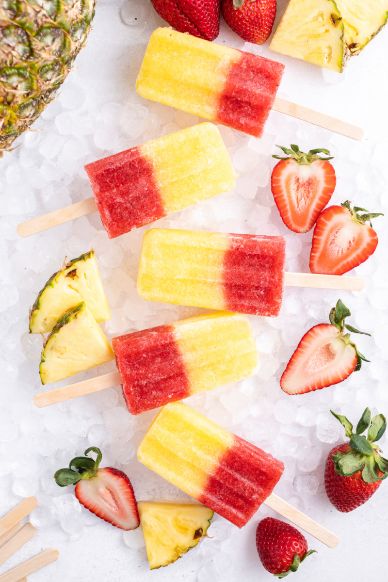 5 strawberry pineapple popsicles on ice