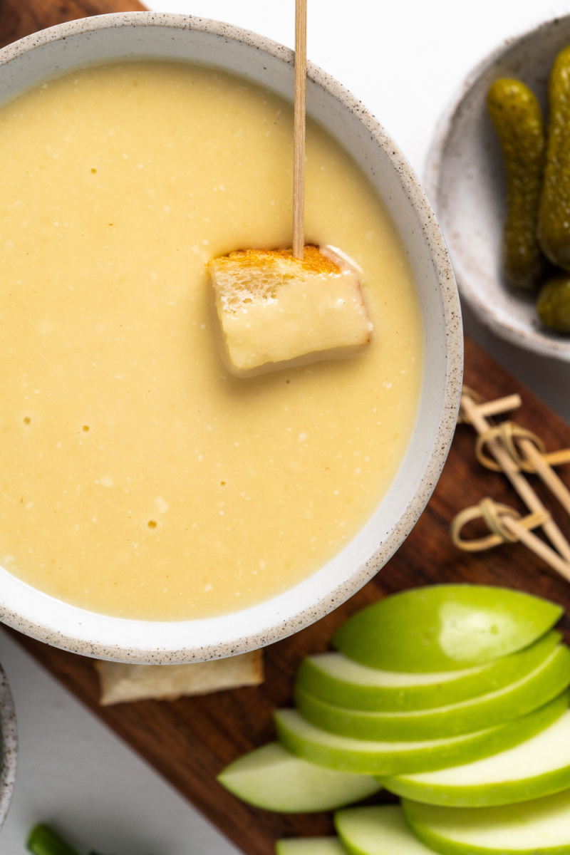 cheese fondue with bread dunked into it