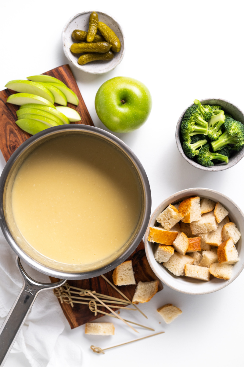 cheese fondue in a pot surrounded by dunkers