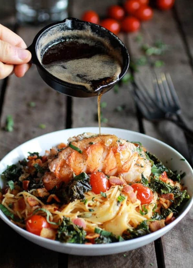 Pouring brown butter onto Lobster, Bacon, Kale and Fontina Pasta