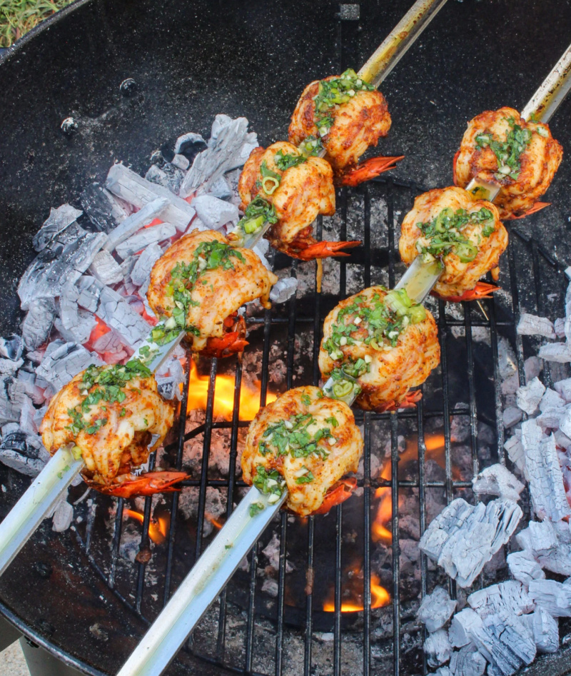 grilled lobster tail skewers over fire