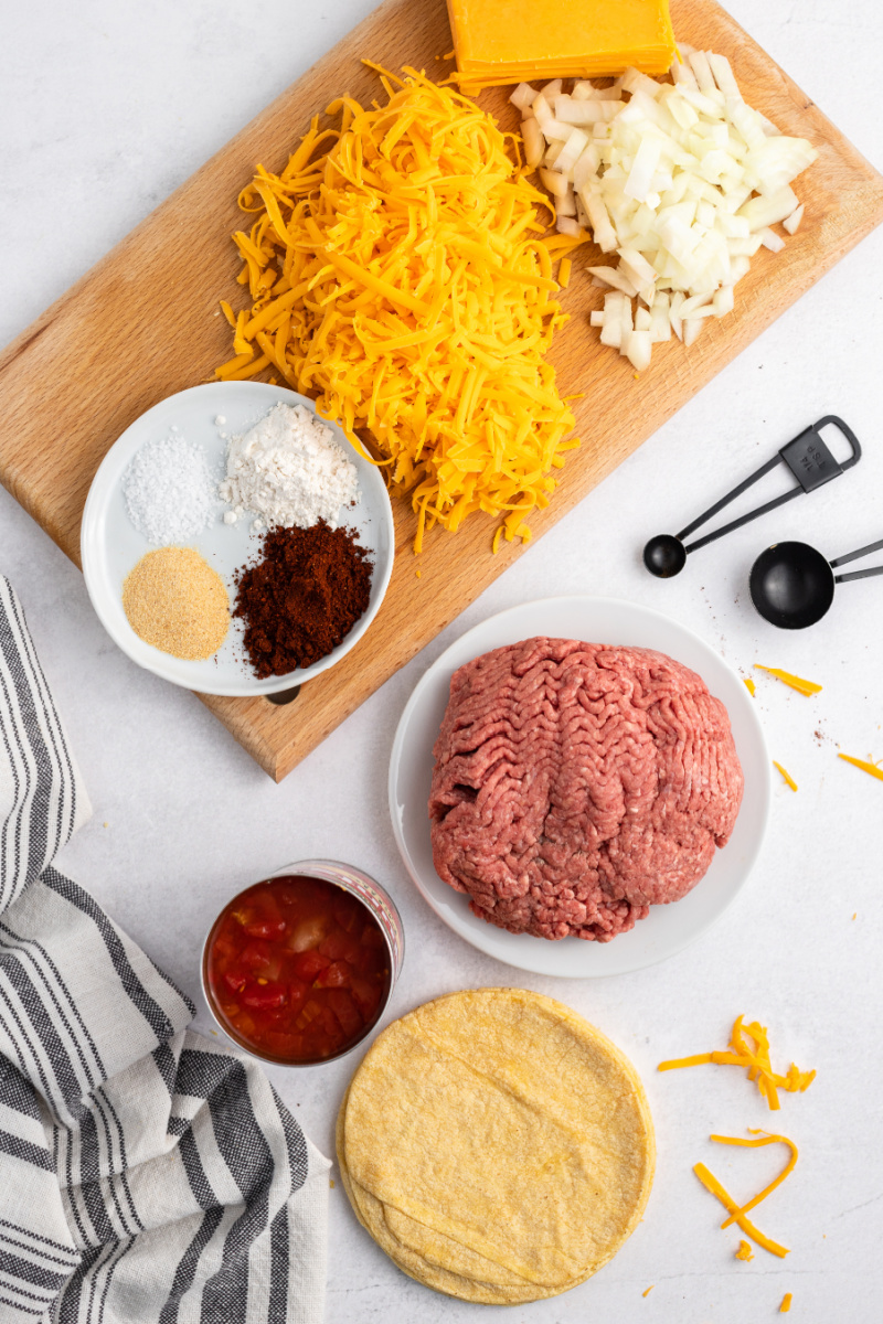 ingredients displayed for making ground beef and cheese enchiladas