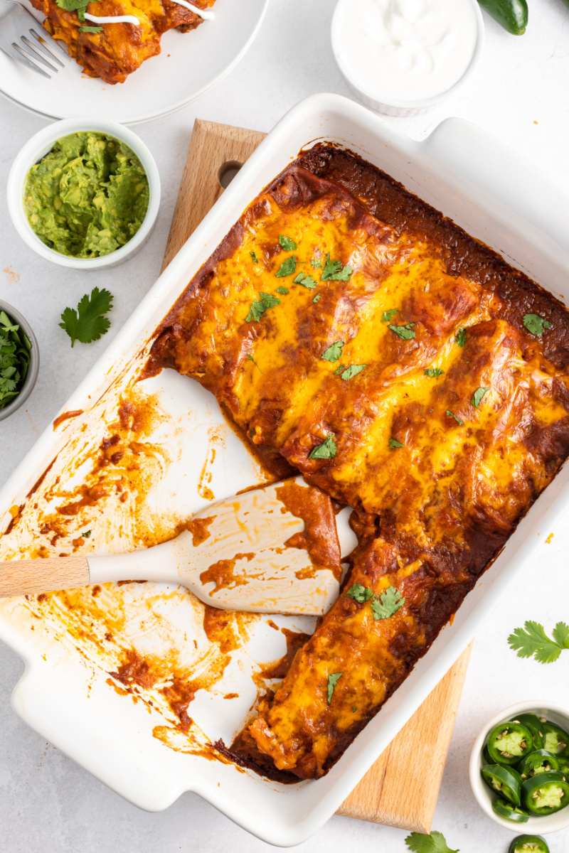 ground beef and cheese enchiladas cut into in a casserole dish