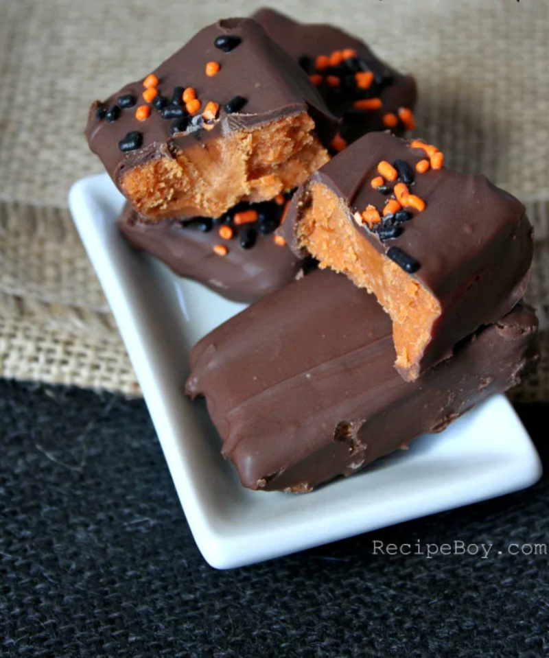 homemade butterfinger candy bars on white plate and one cut open