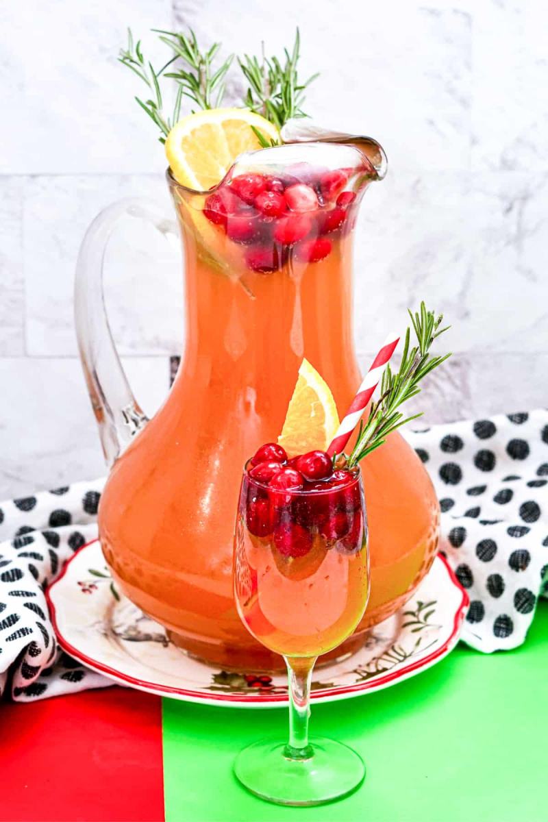 pitcher of cranberry christmas punch and glass of punch